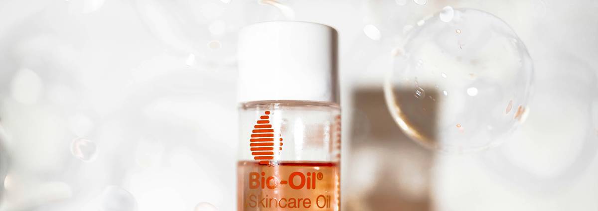 woman applying skincare oil face is bio good to clean skin in natural light