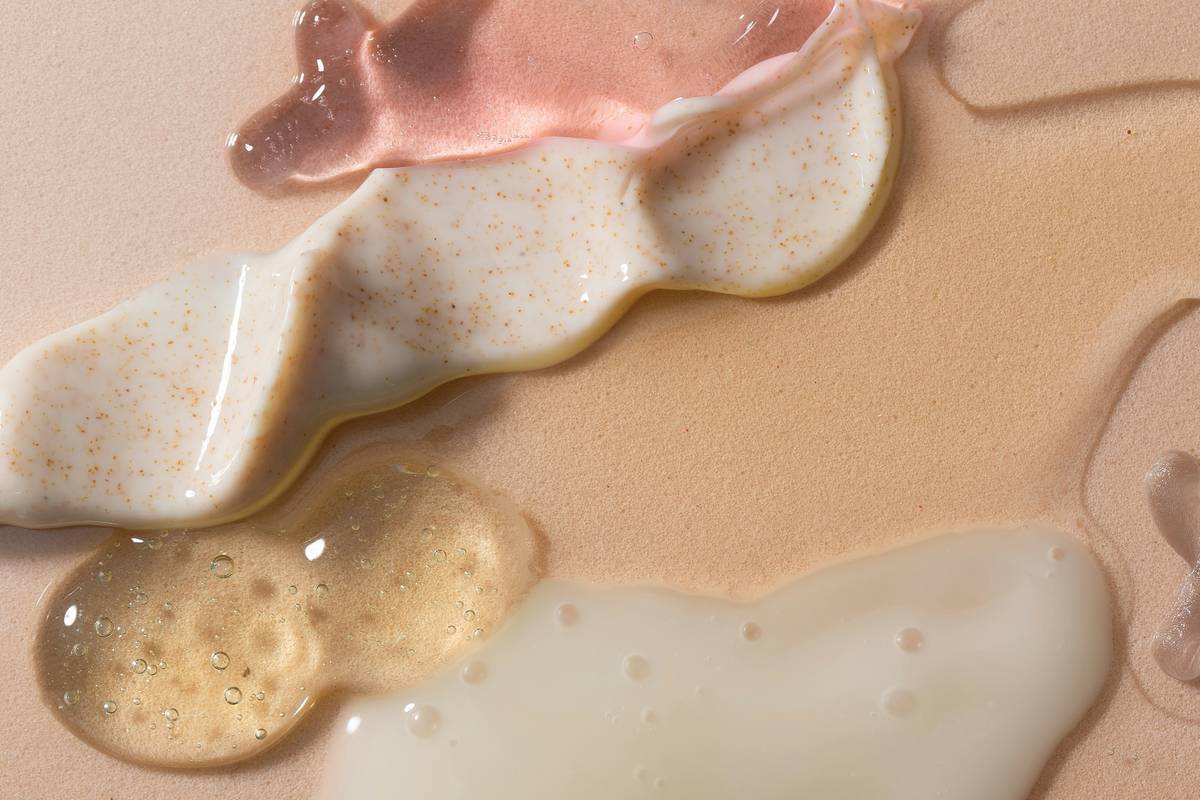 Close-up of how to use oil on face showing dropper dispensing two drops into palm